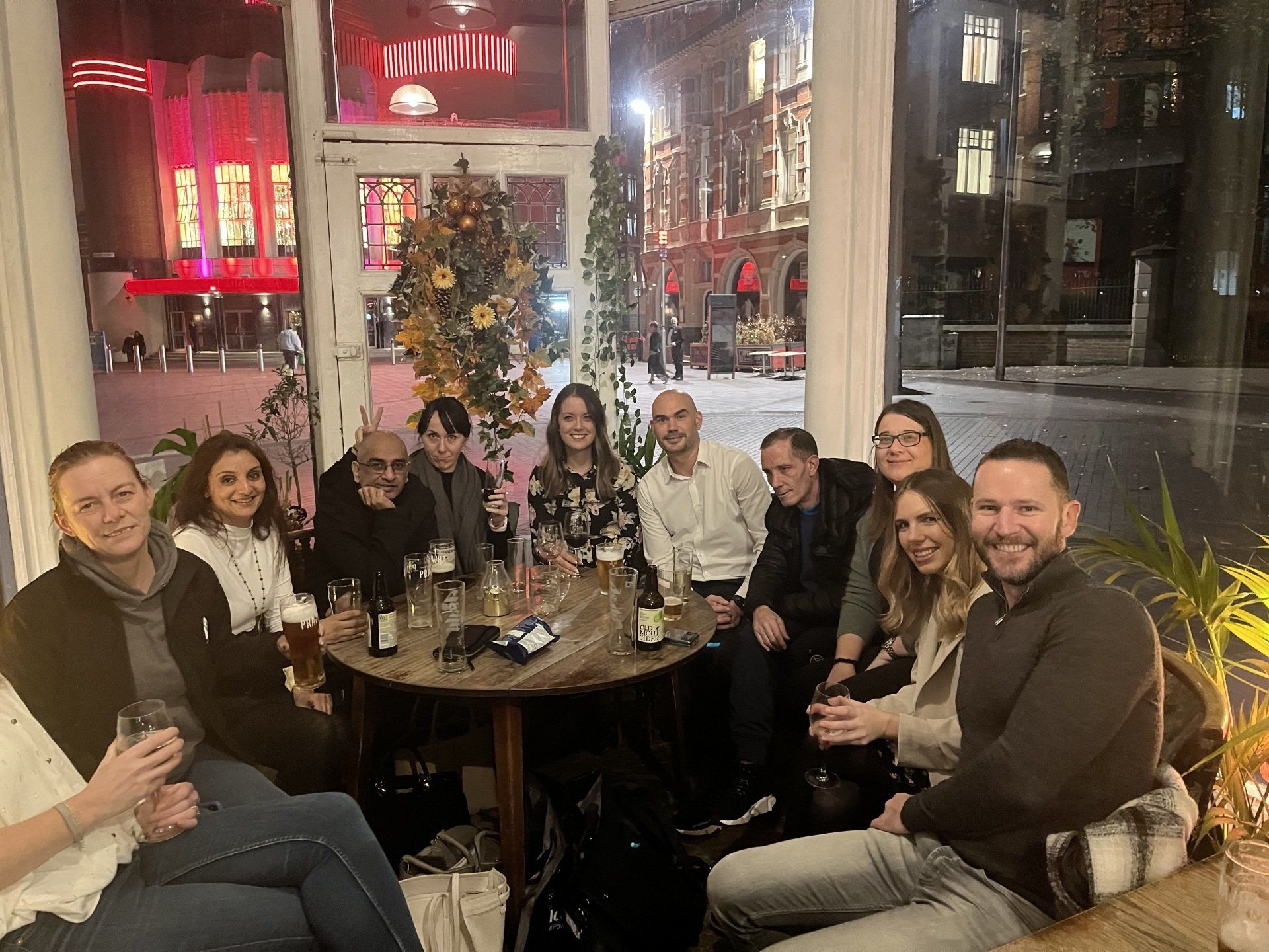 A group of people are sitting around a table in a restaurant.