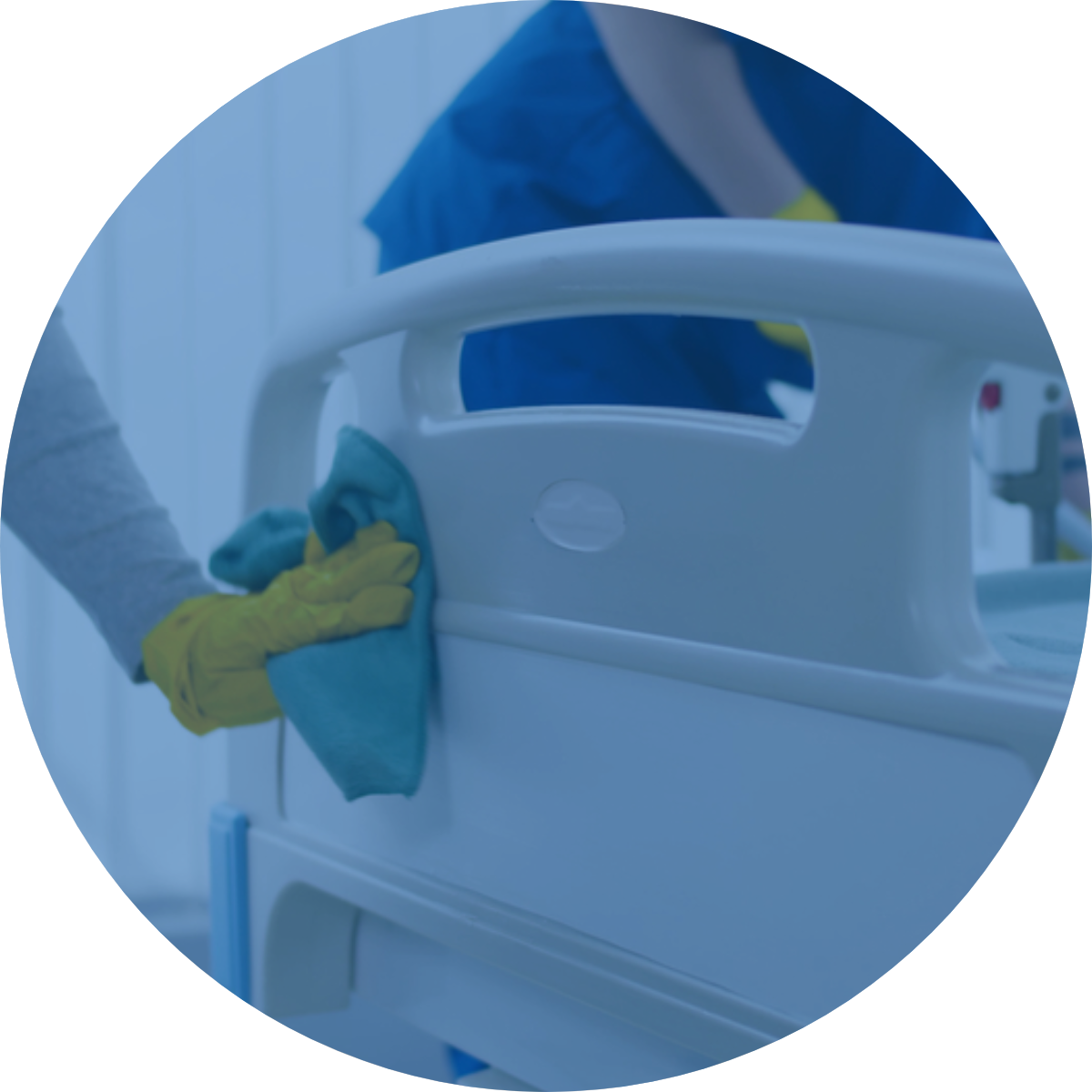 A person is cleaning a hospital bed with a cloth