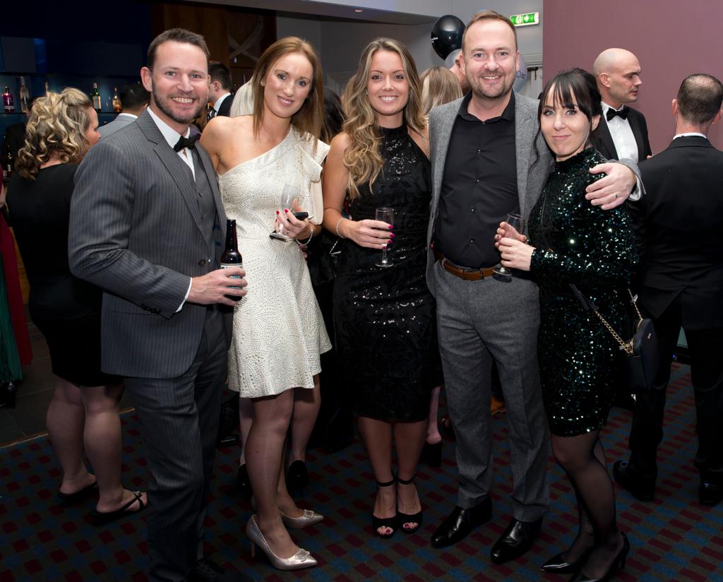 A group of people are posing for a picture at a party.