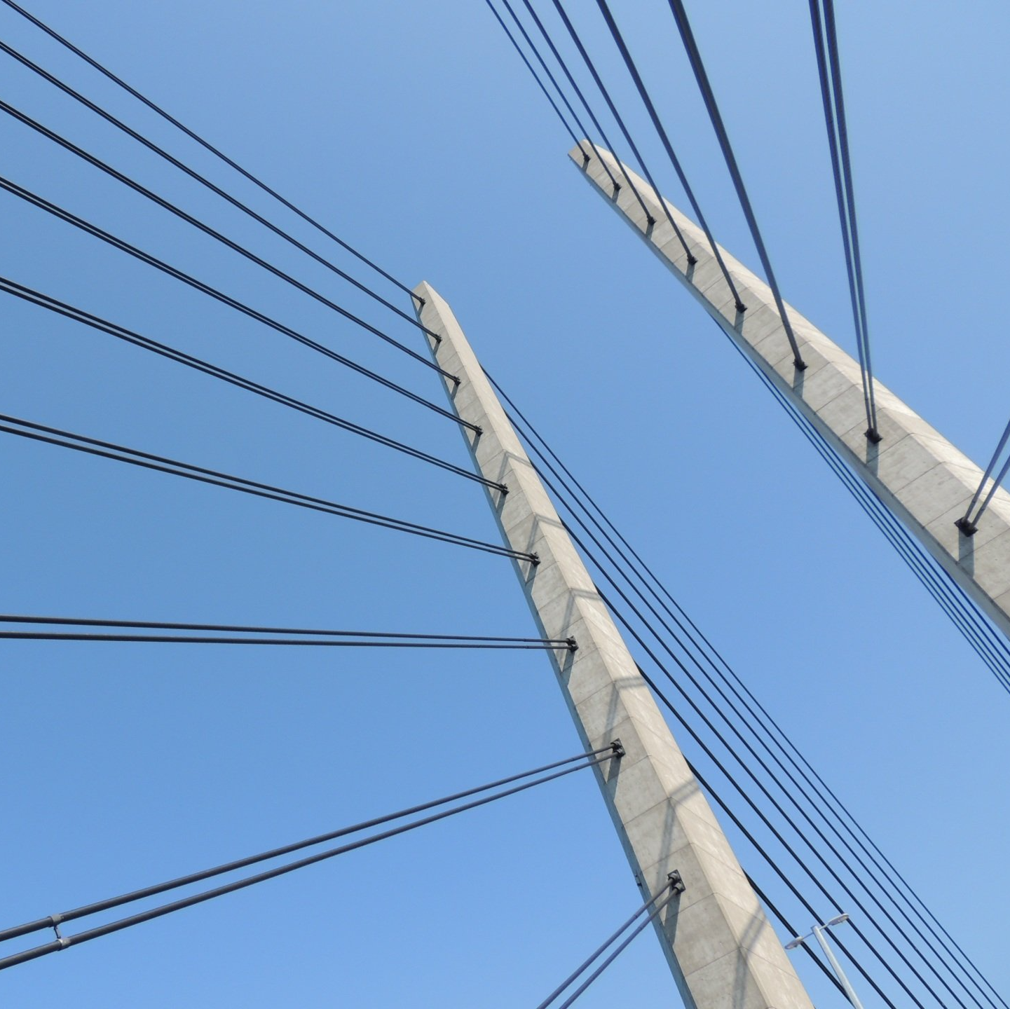 Looking up at a bridge with a blue sky in the background
