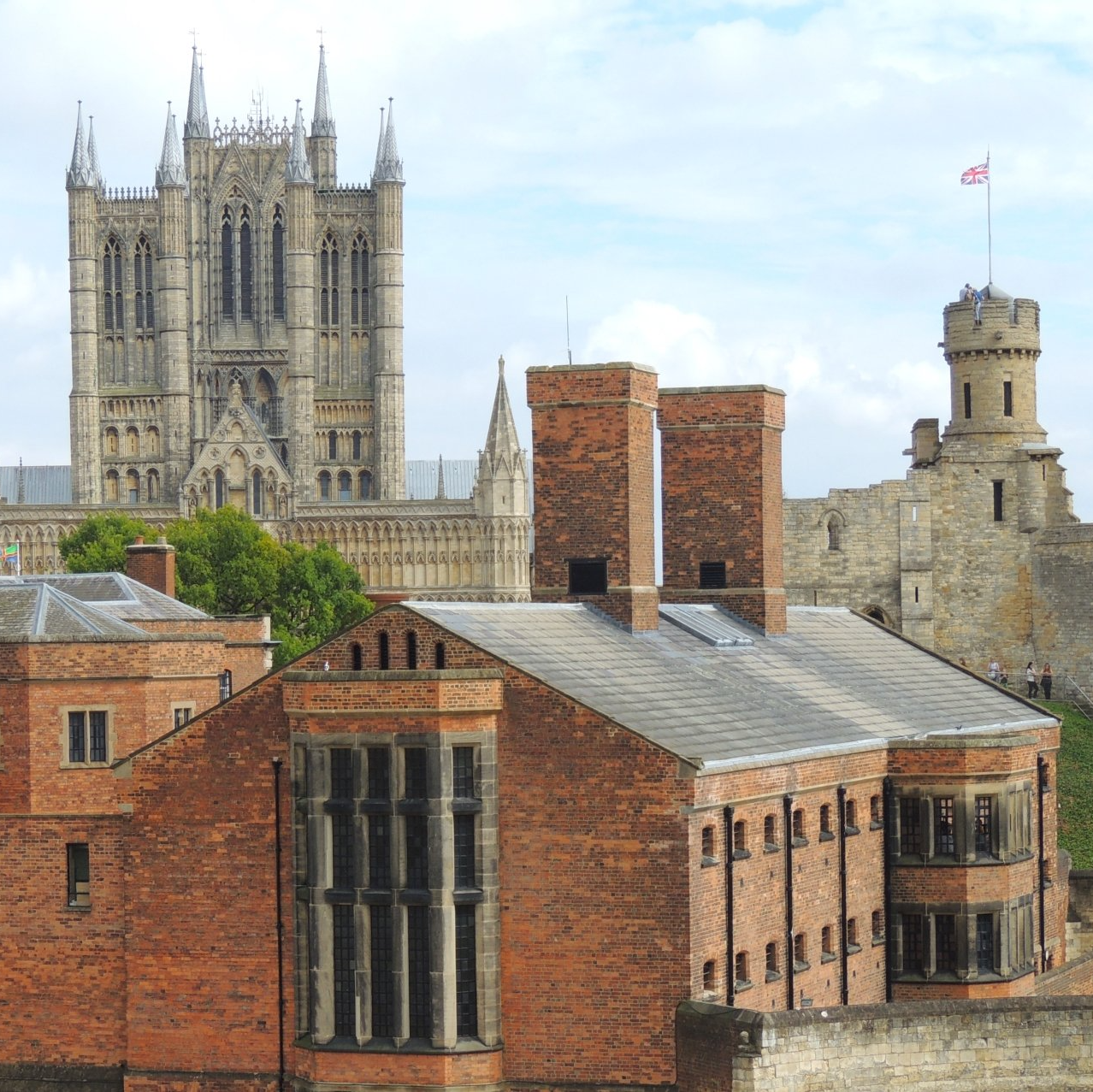 A large brick building with a castle in the background