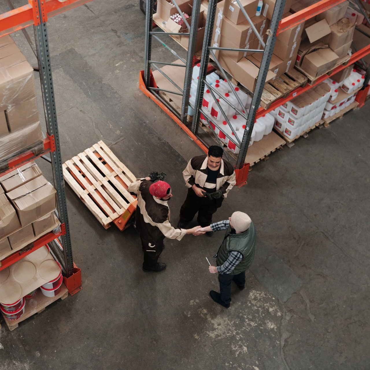 A group of people shaking hands in a warehouse