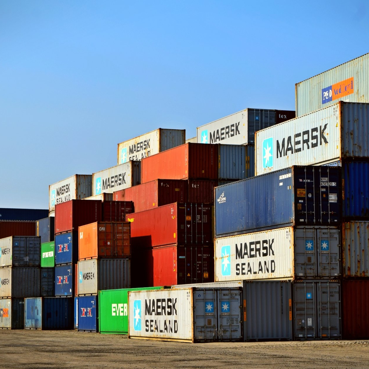 Maersk sealand shipping containers are stacked on top of each other