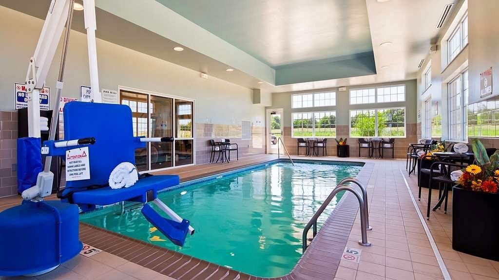 An indoor swimming pool with a wheelchair lift attached to it.