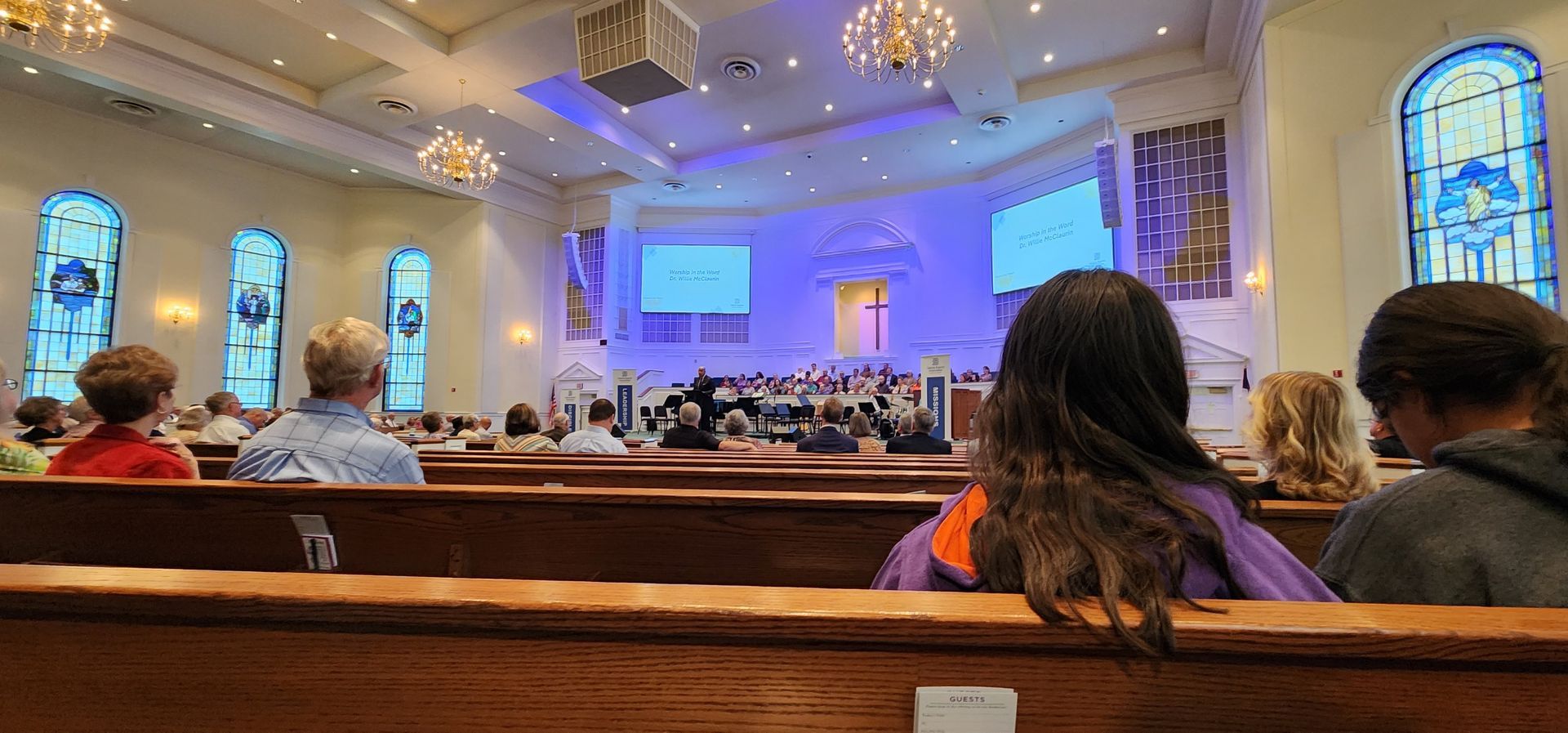 A group of people are sitting in a church.