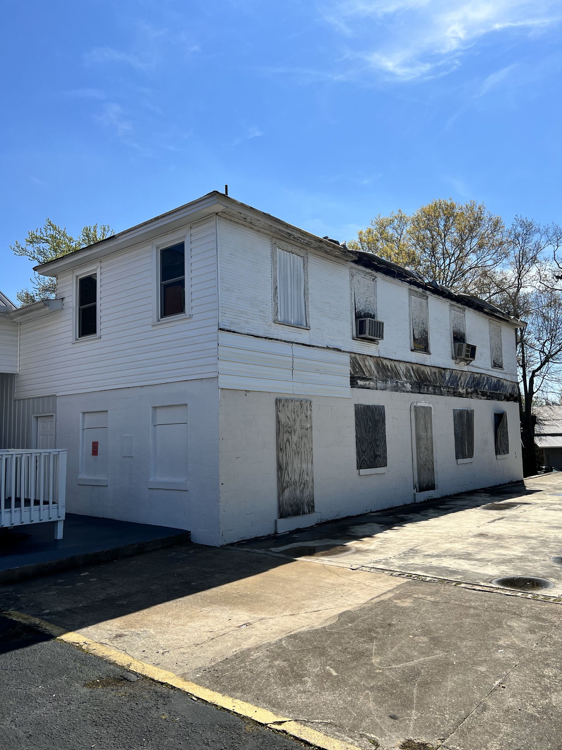 A white building with a blue sky in the background