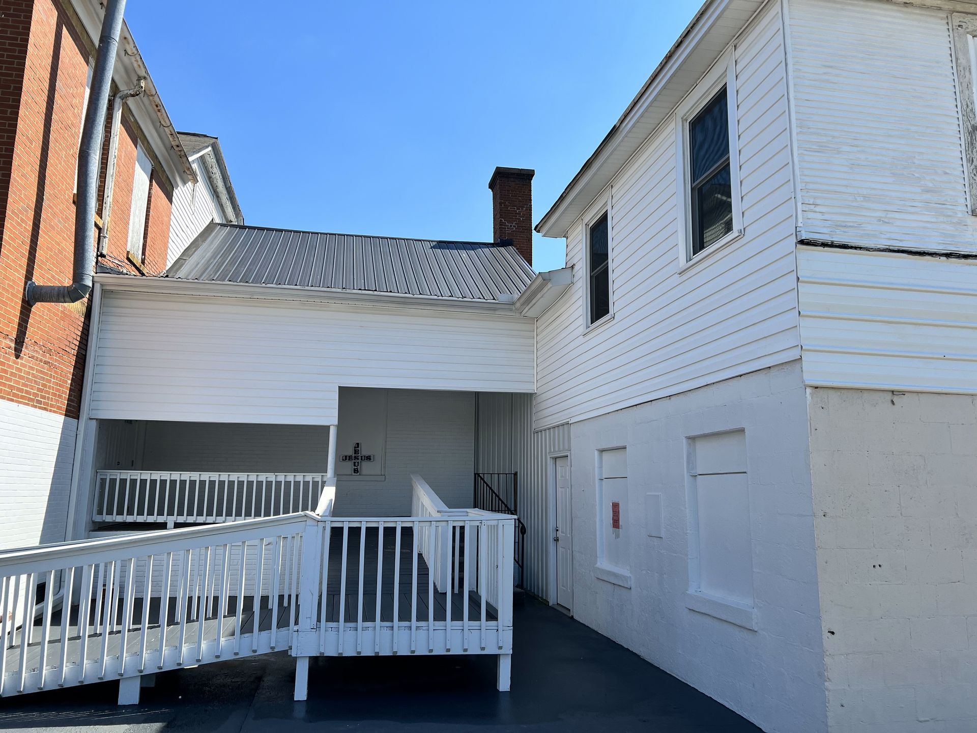 A white building with a ramp leading to it
