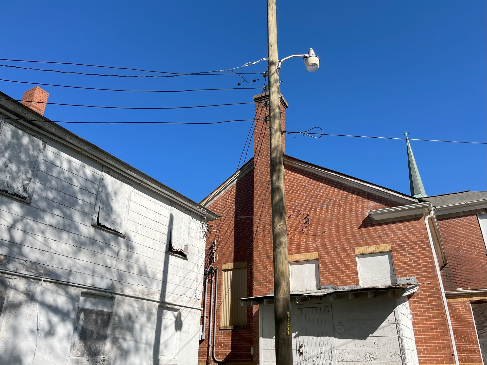A brick building with a chimney and a street light