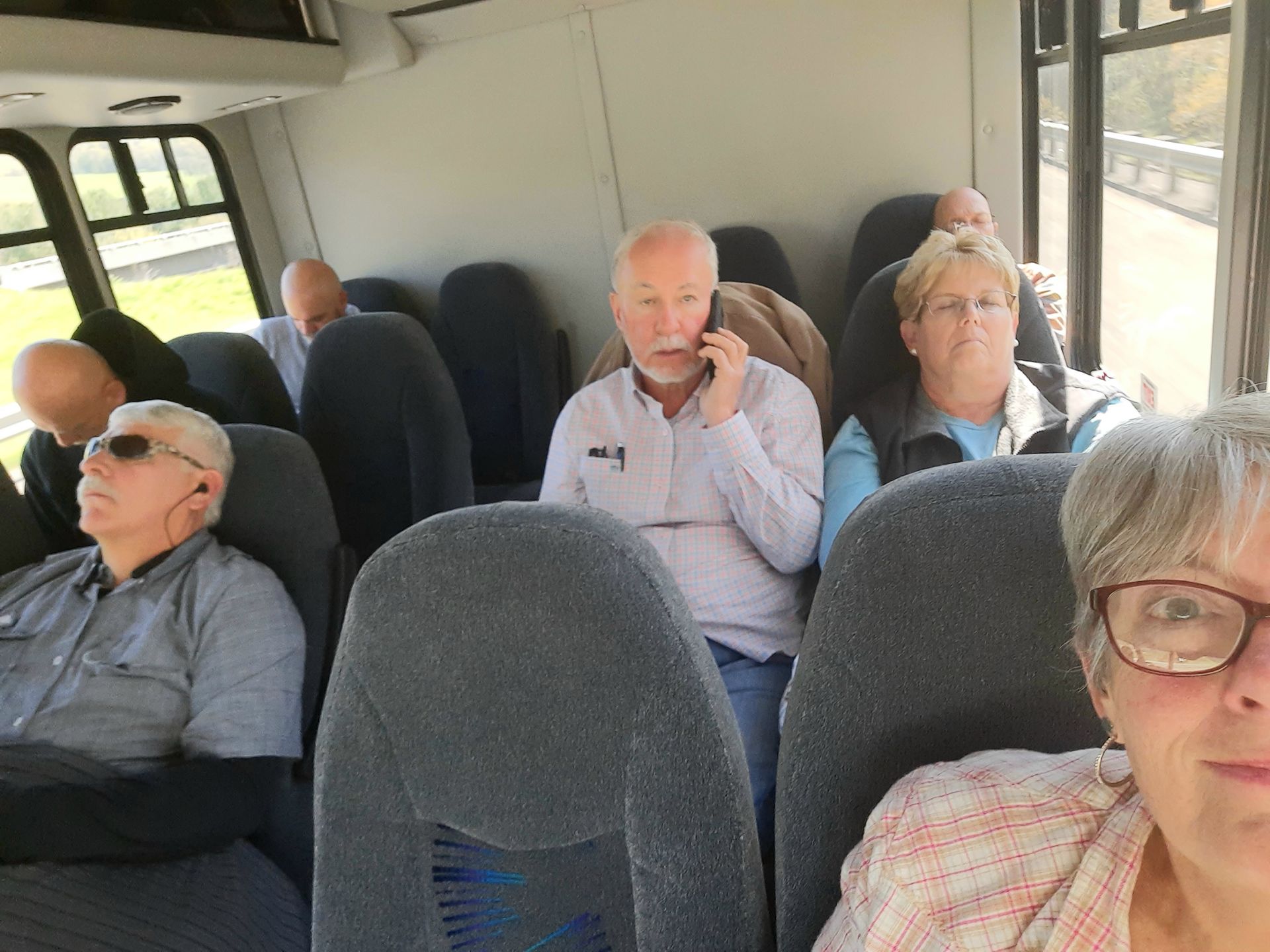A group of people are sitting on a bus.