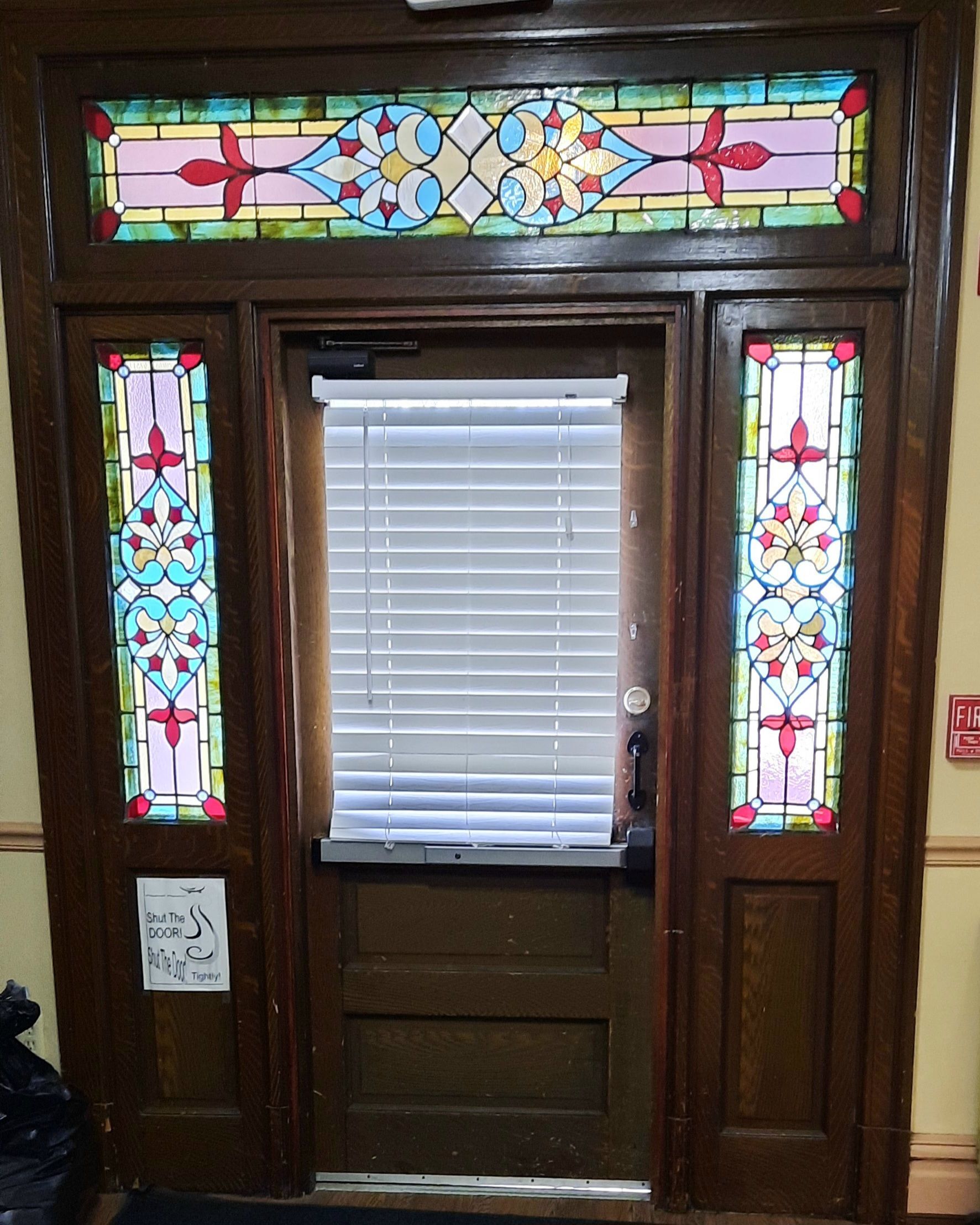 A door with a stained glass window above it
