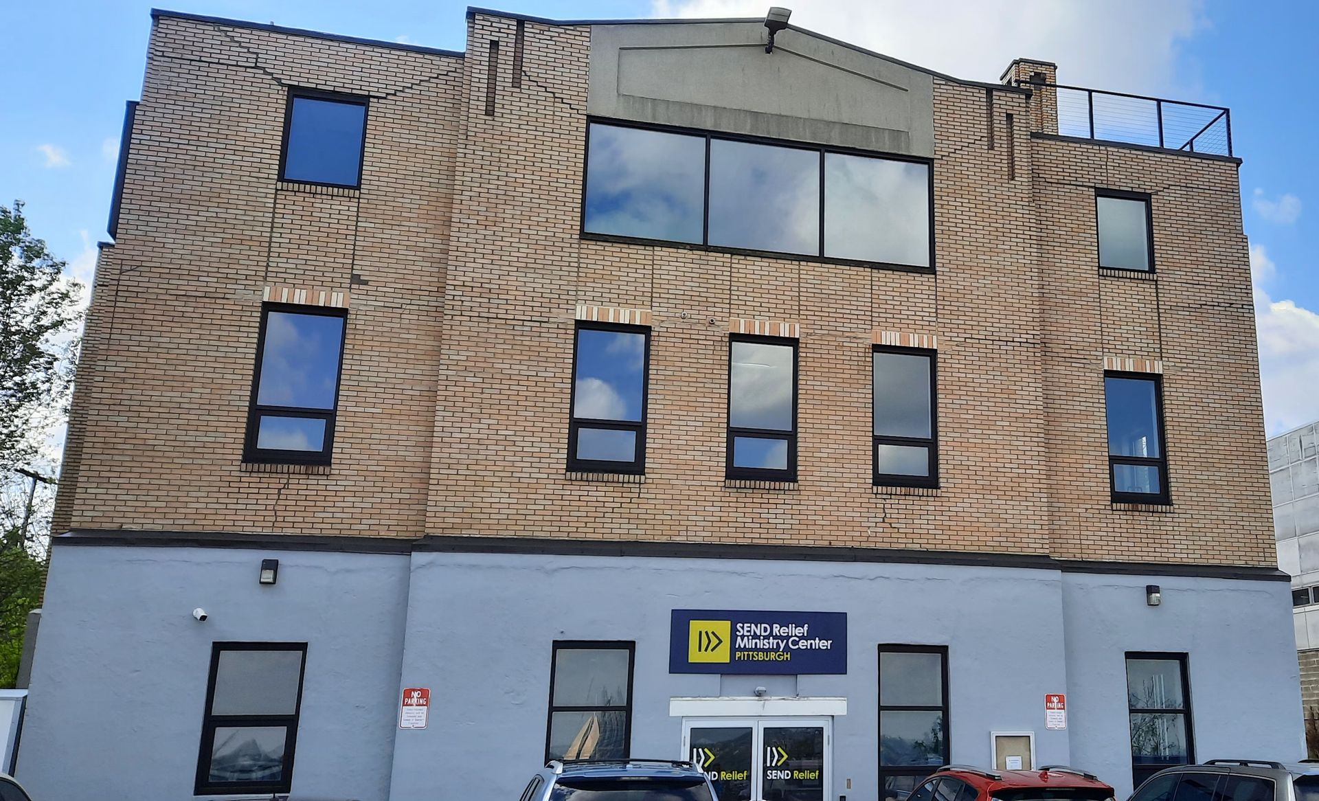 A building with a lot of windows and a sign that says ' dental ' on it