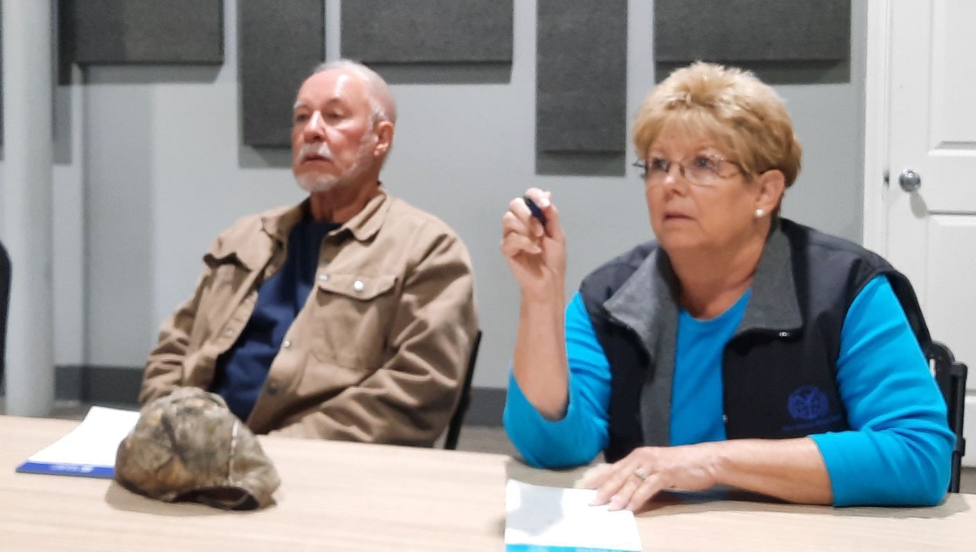 A man and a woman are sitting at a table talking