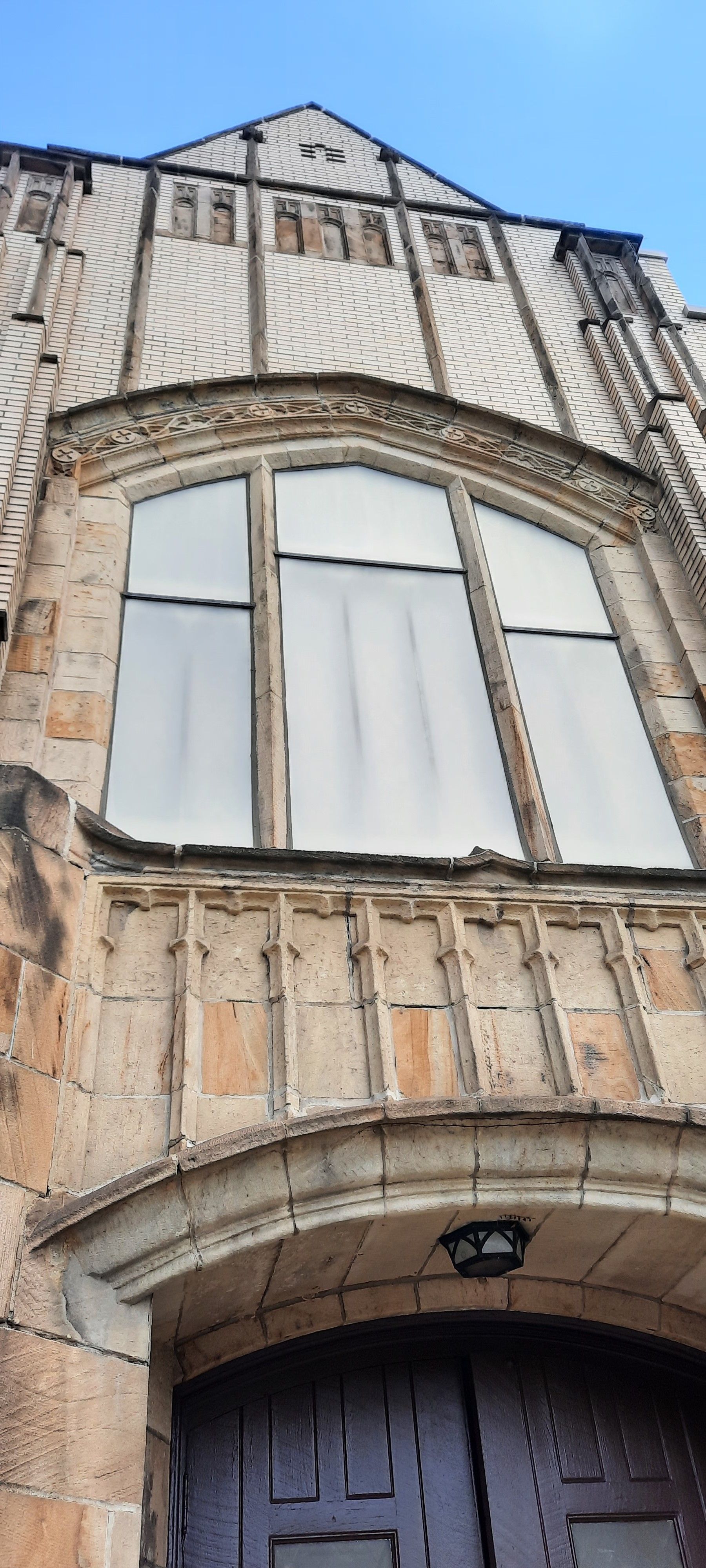 The front of a building with a large window and a door.