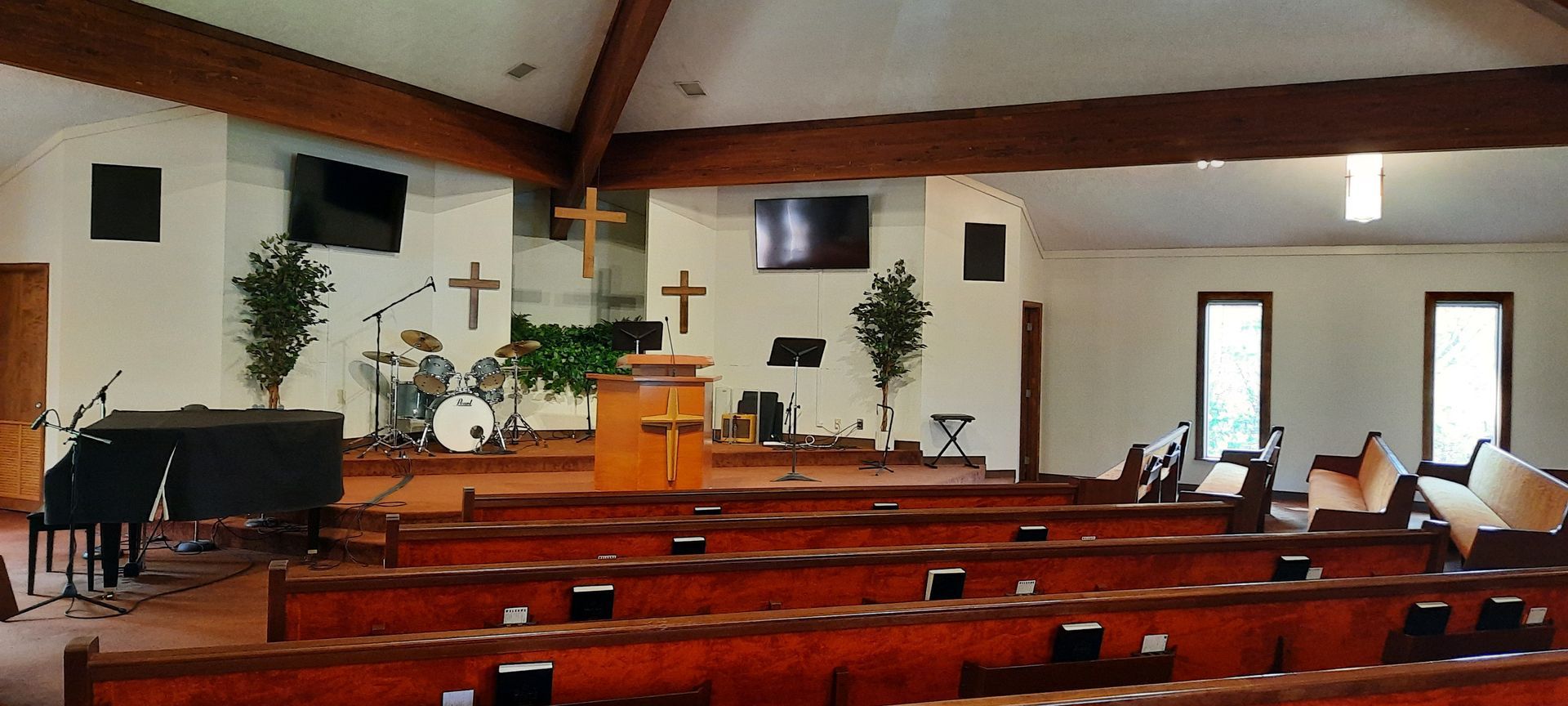 An empty church with a podium and a piano