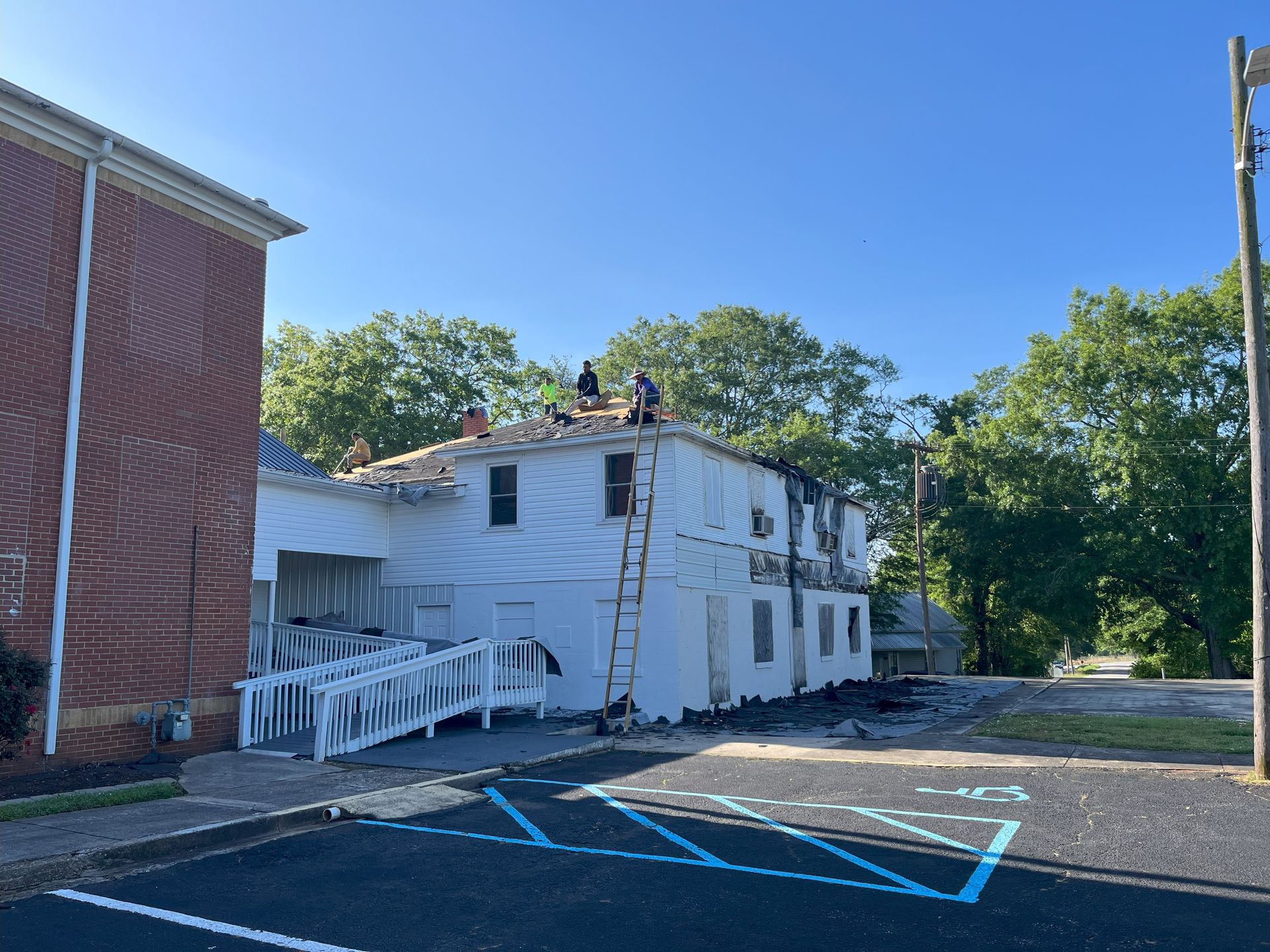 A group of people are working on the roof of a building.