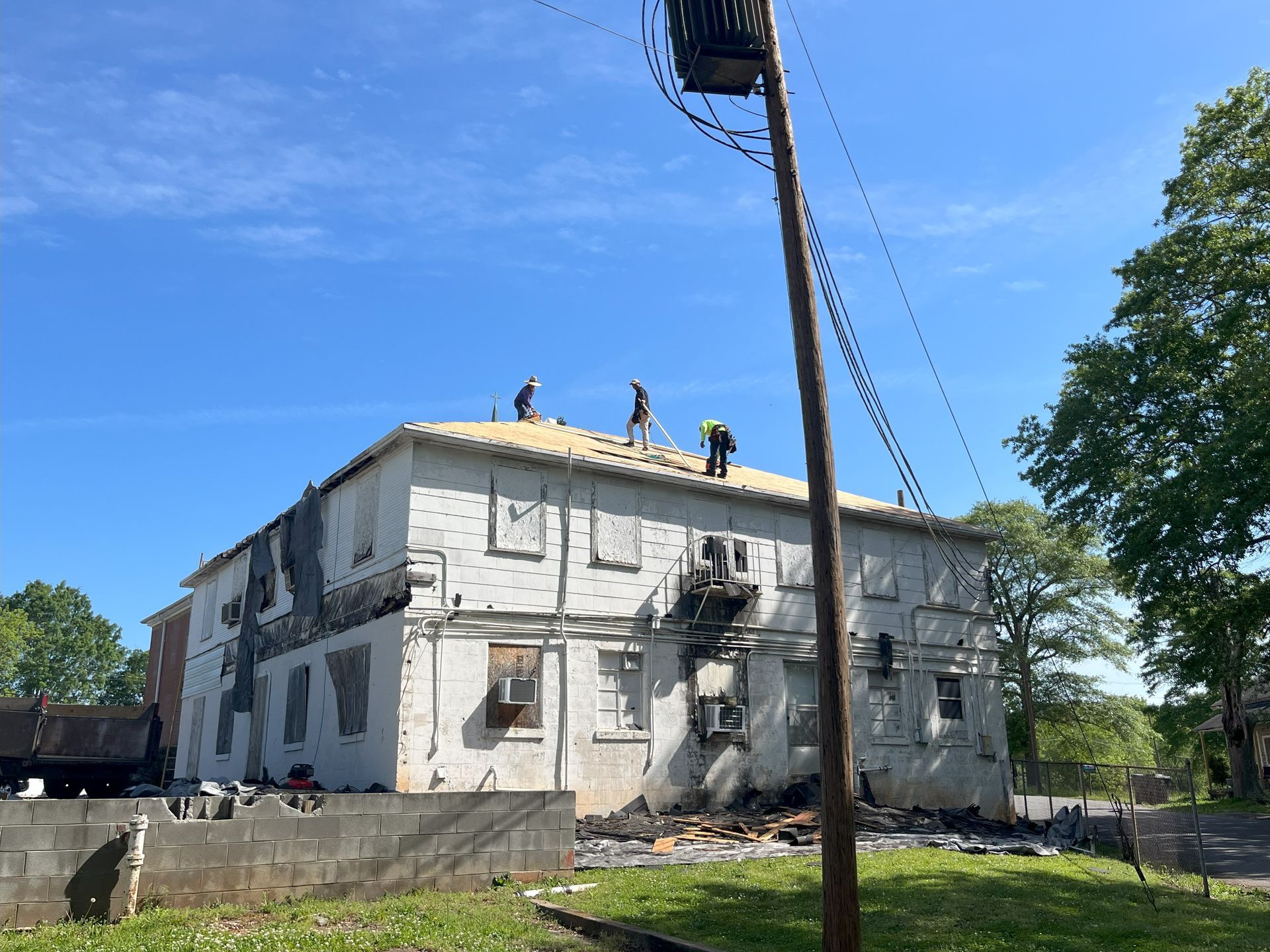 A group of people are working on the roof of a building.