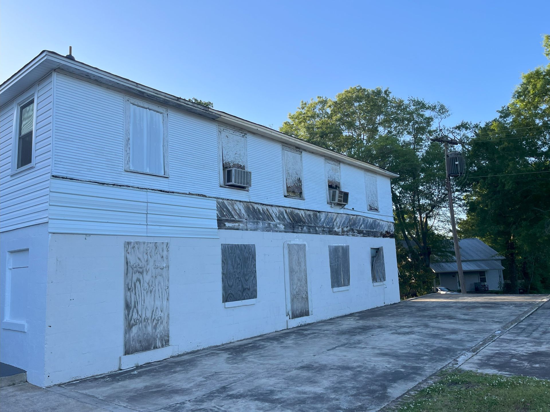 A white building with a lot of windows and a blue sky in the background