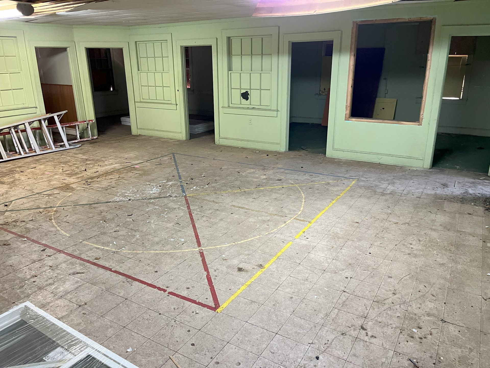 An empty room with a yellow line on the floor.