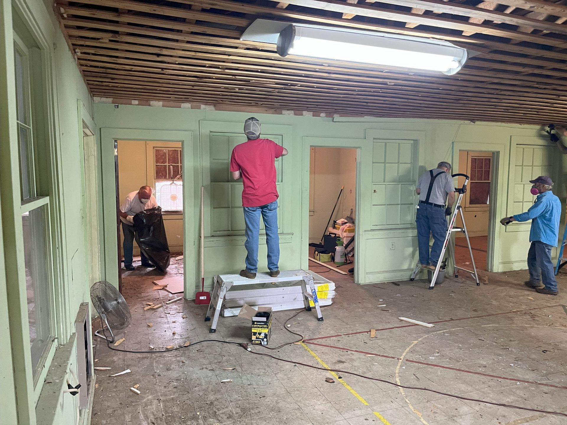 A group of men are working on a house.