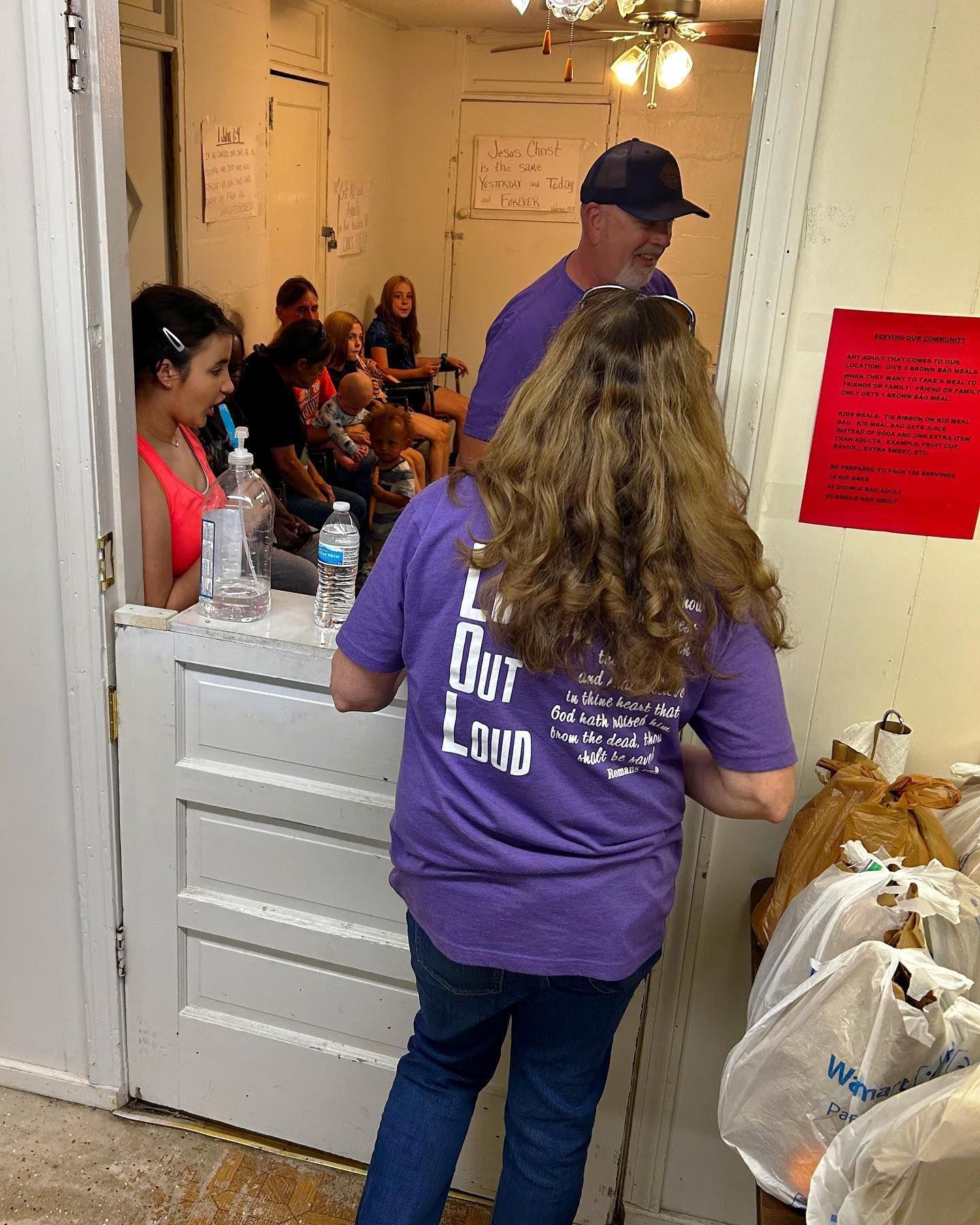 A woman wearing a purple shirt that says i love out land