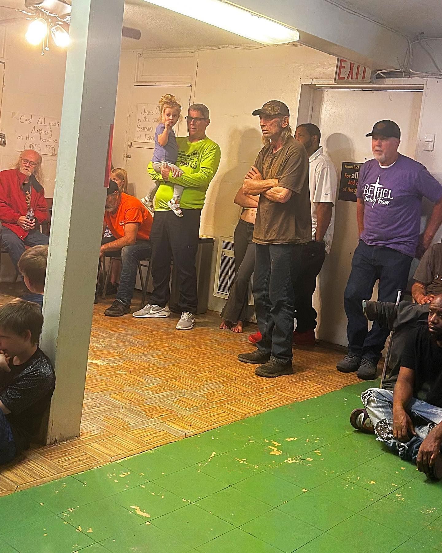 A group of people are sitting on the floor in a room.