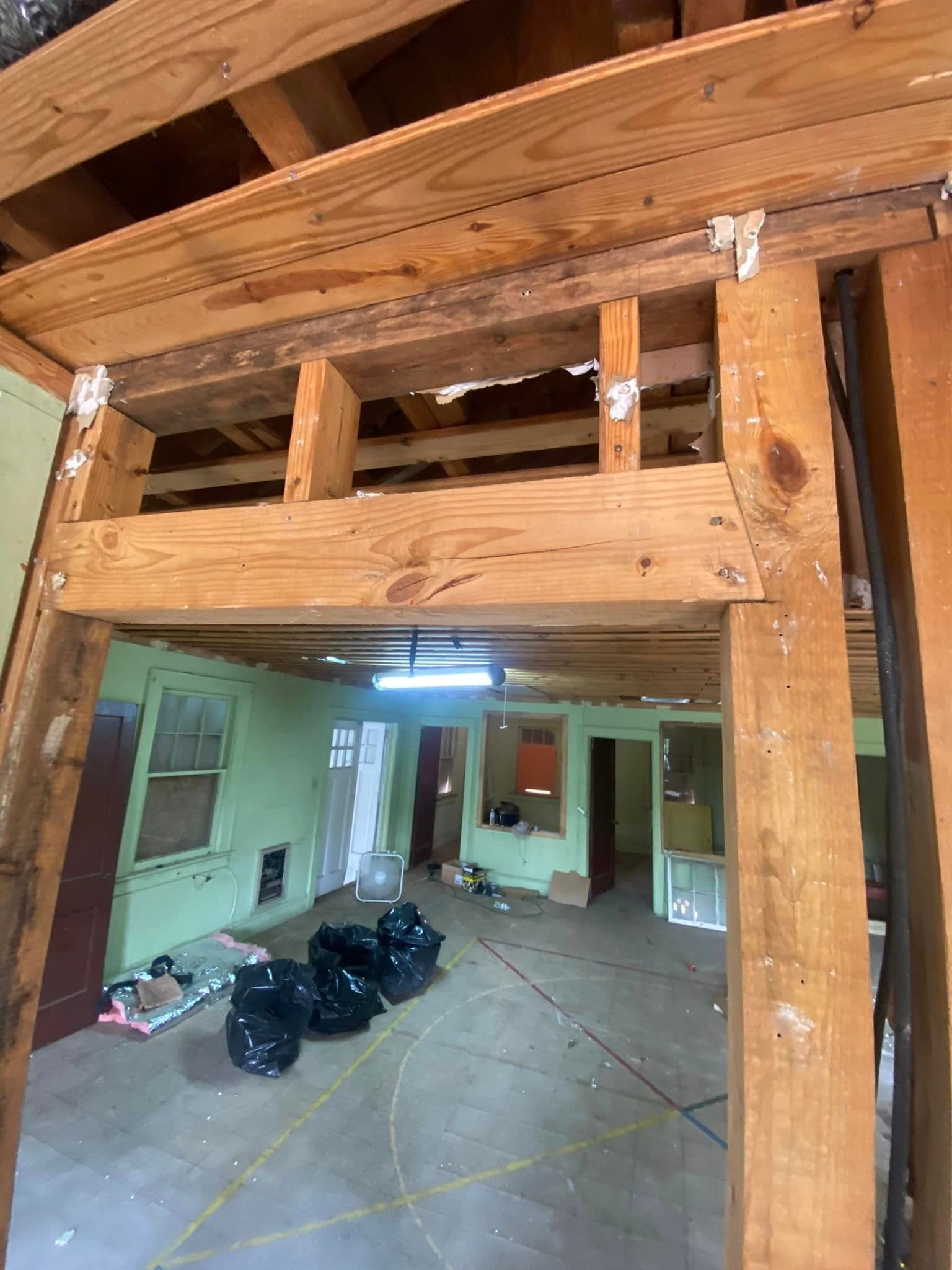 A room with a lot of wooden beams and a ceiling.