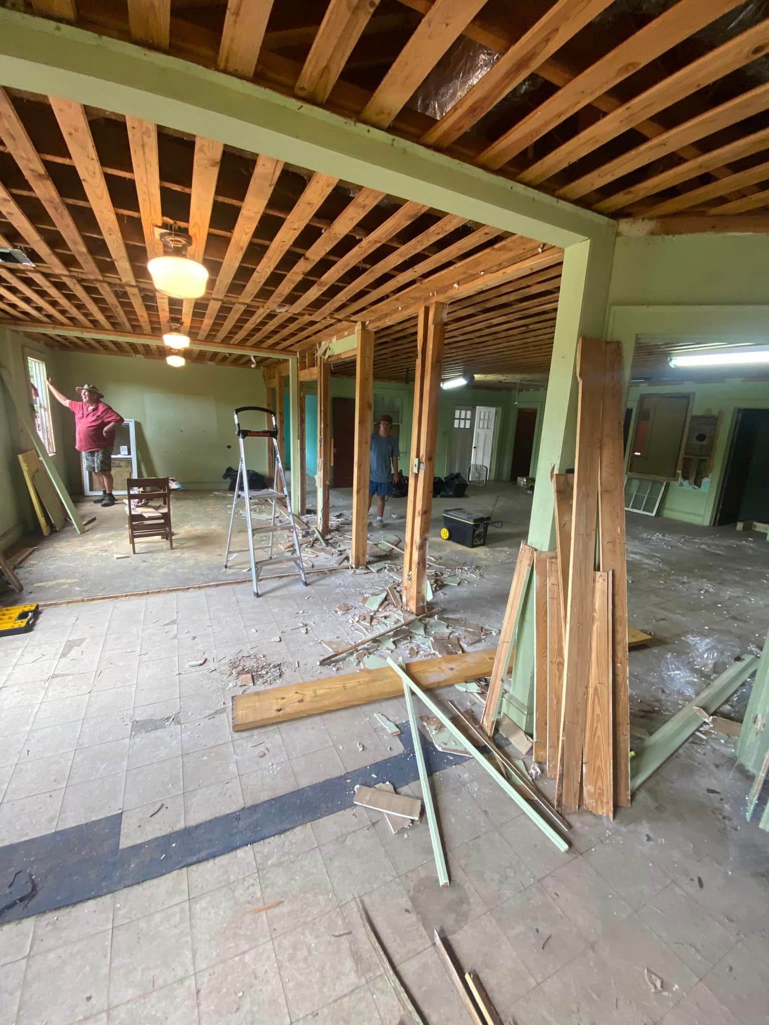 A large room with a wooden ceiling is being remodeled.