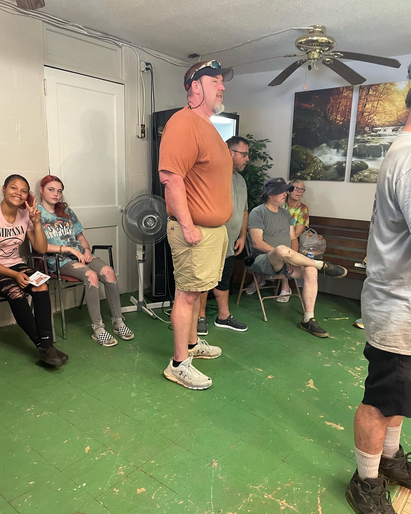 A group of people are sitting in chairs in a waiting room.