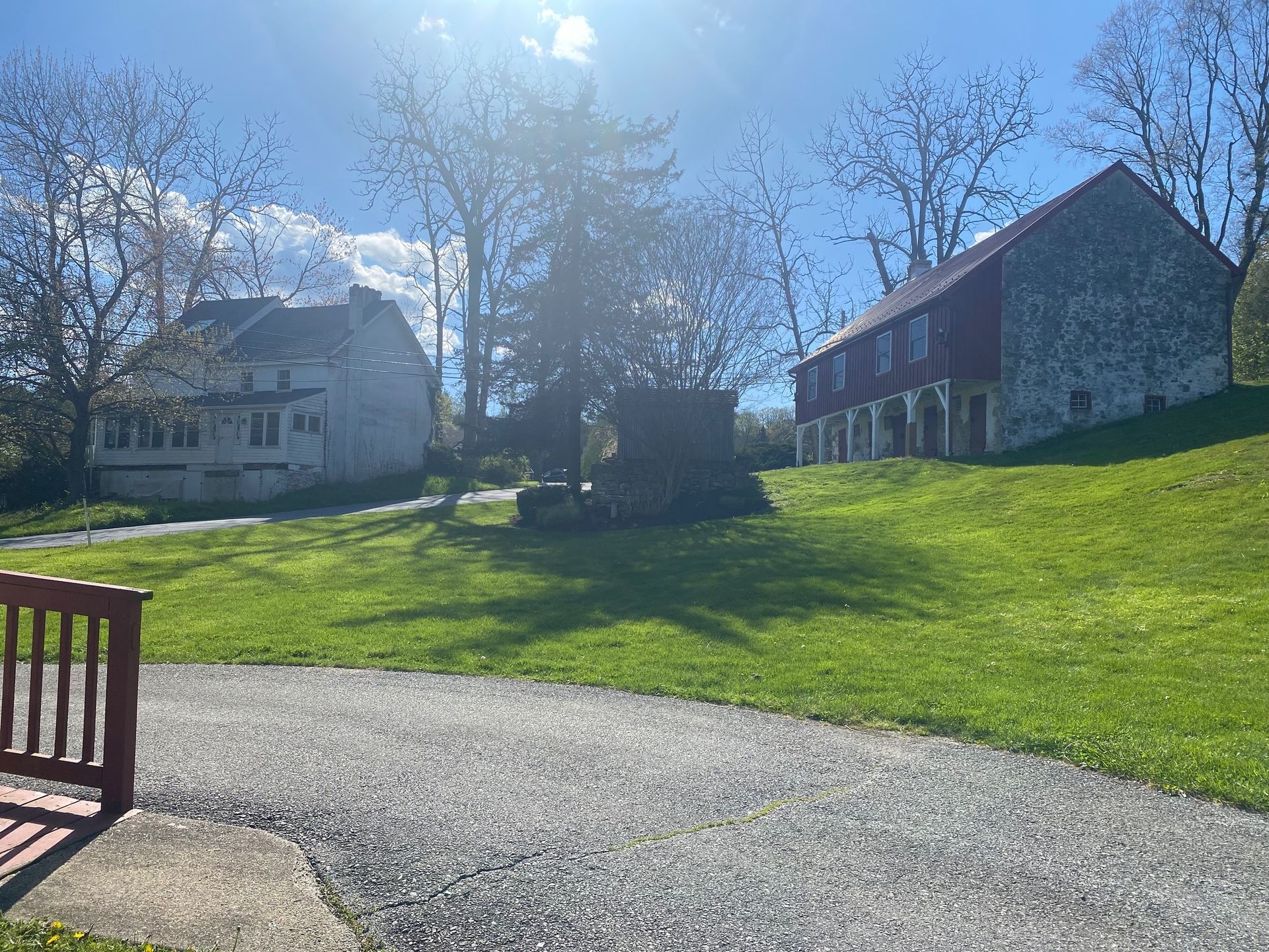 There are two houses in the background and a bench in the foreground.