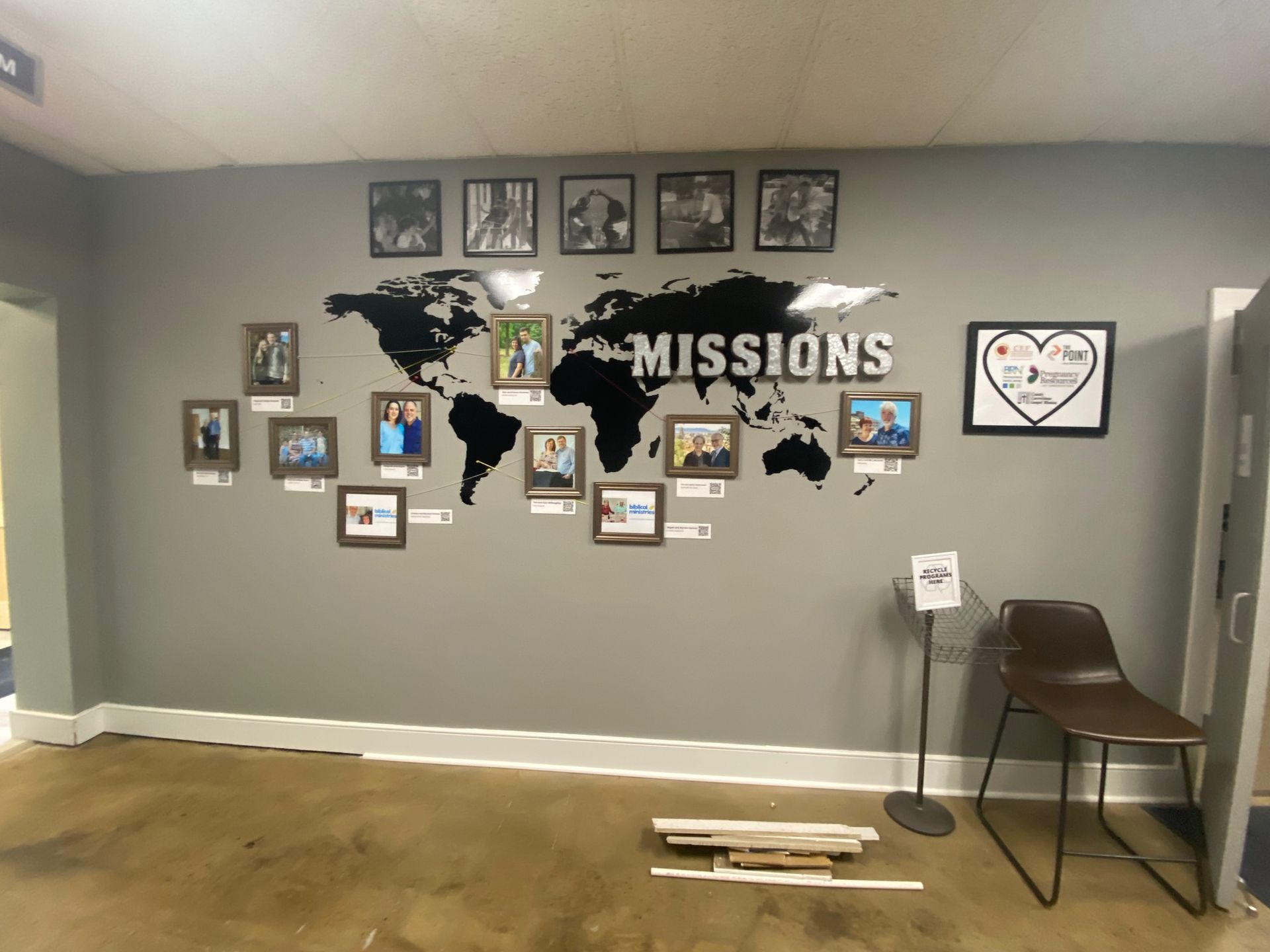 A wall with a map of the world and the words missions on it