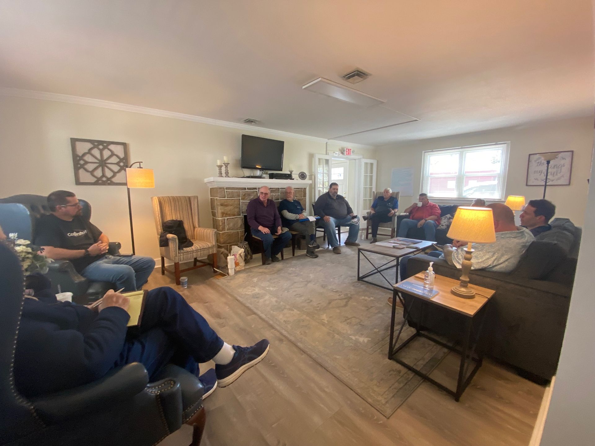 A group of people are sitting in a living room.