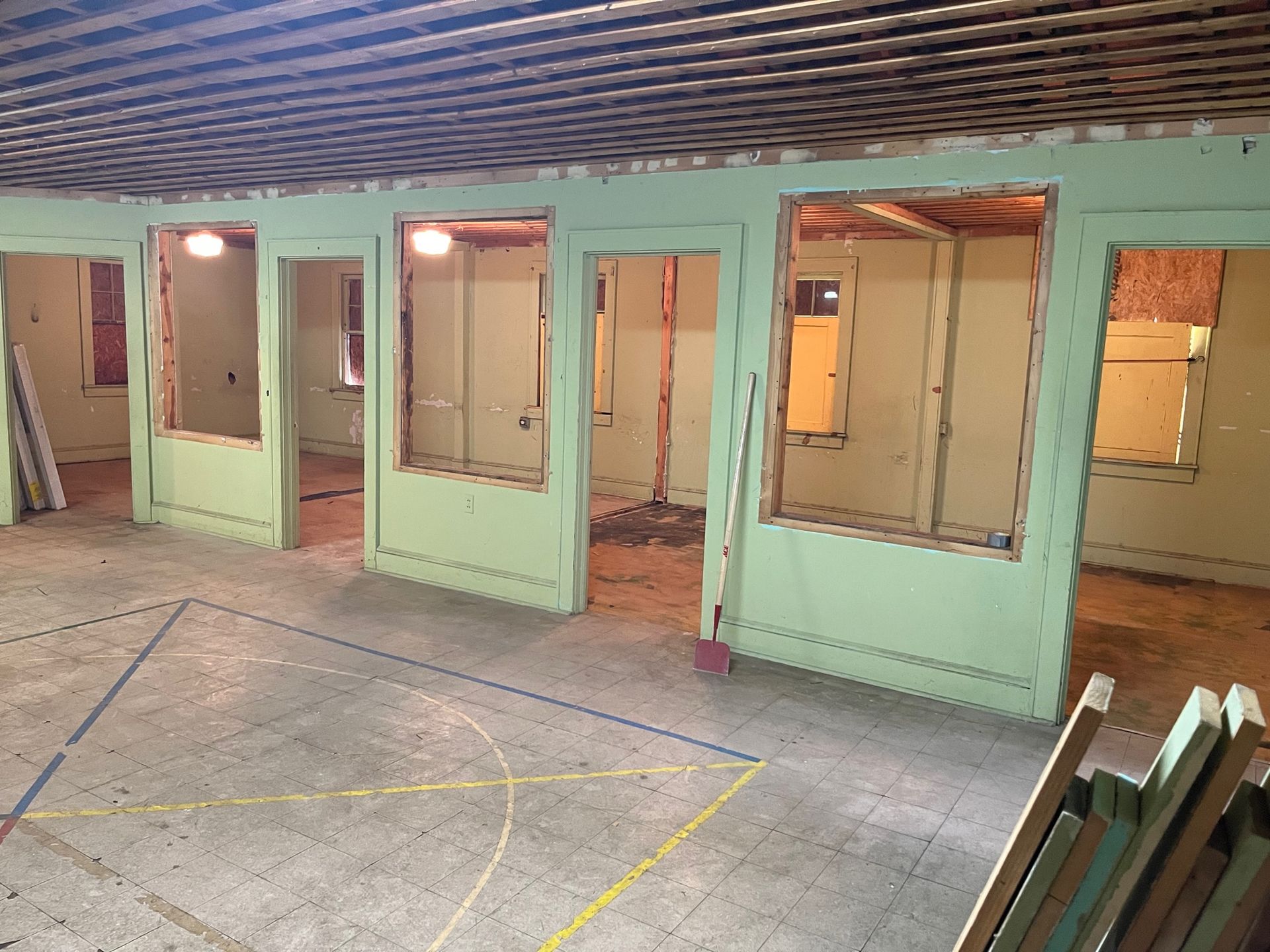 A room with a lot of windows and a yellow line on the floor.