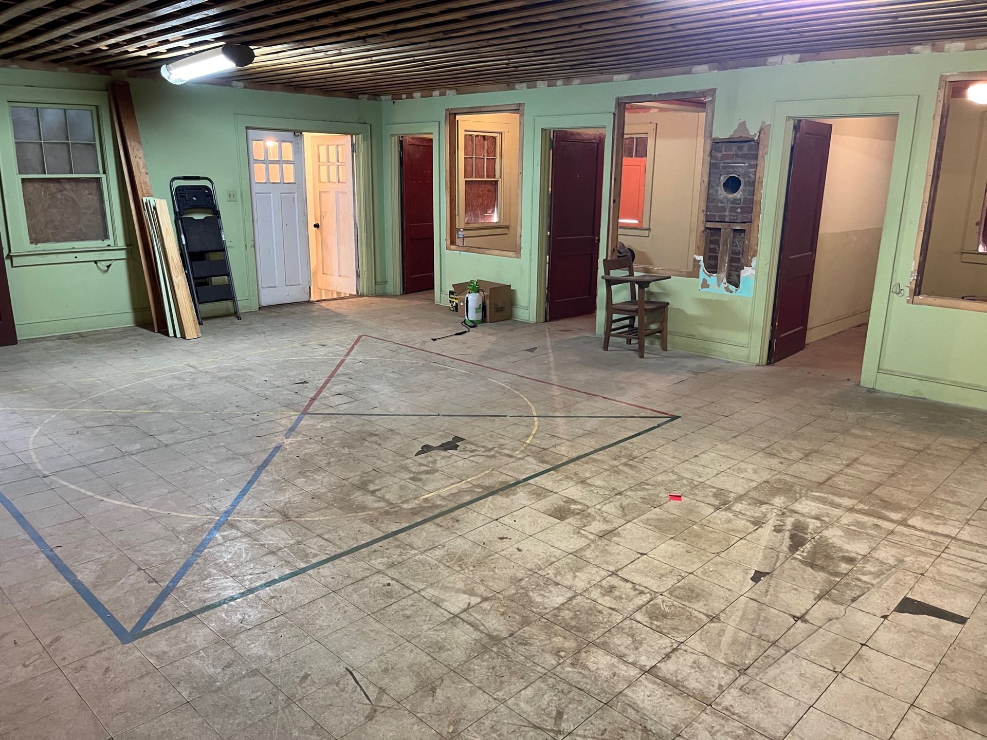 A large room with a lot of windows and doors.