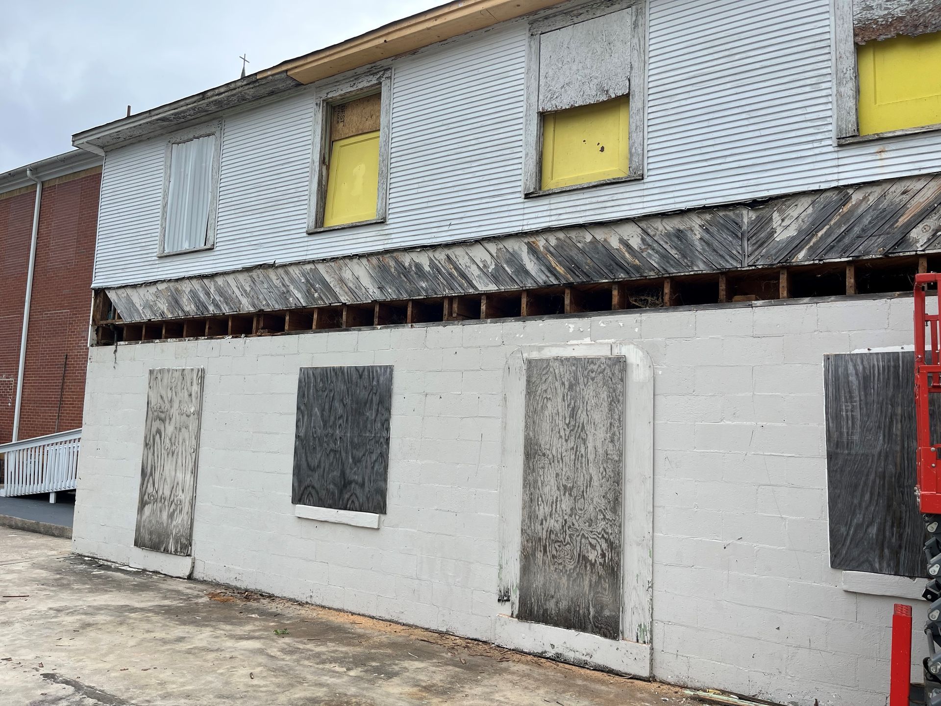 A building with a lot of windows that are boarded up