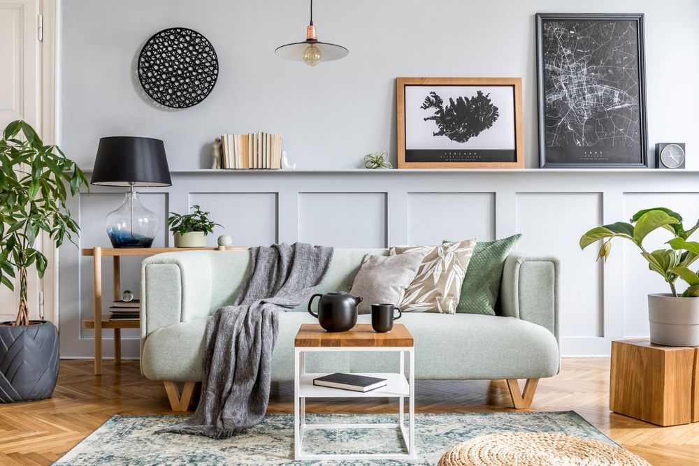 A living room with a couch , table , and plants.