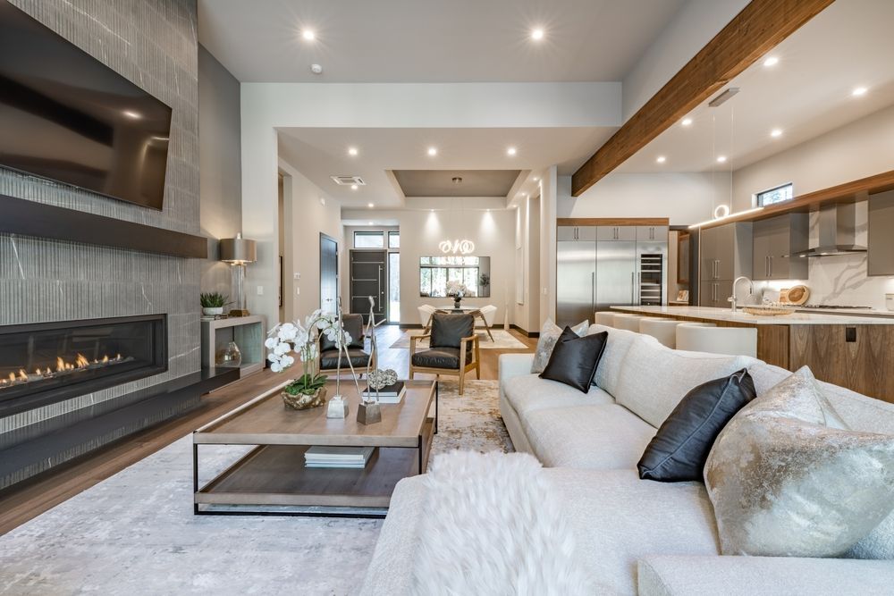 A living room with a couch , coffee table , fireplace and television.