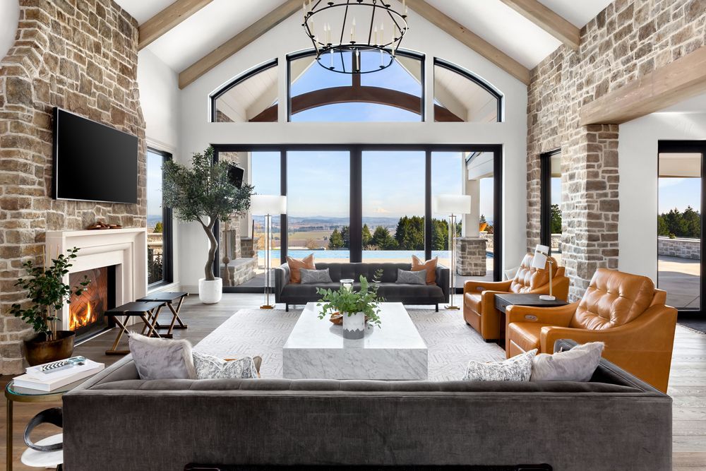 A living room with a couch , chairs , fireplace and television.