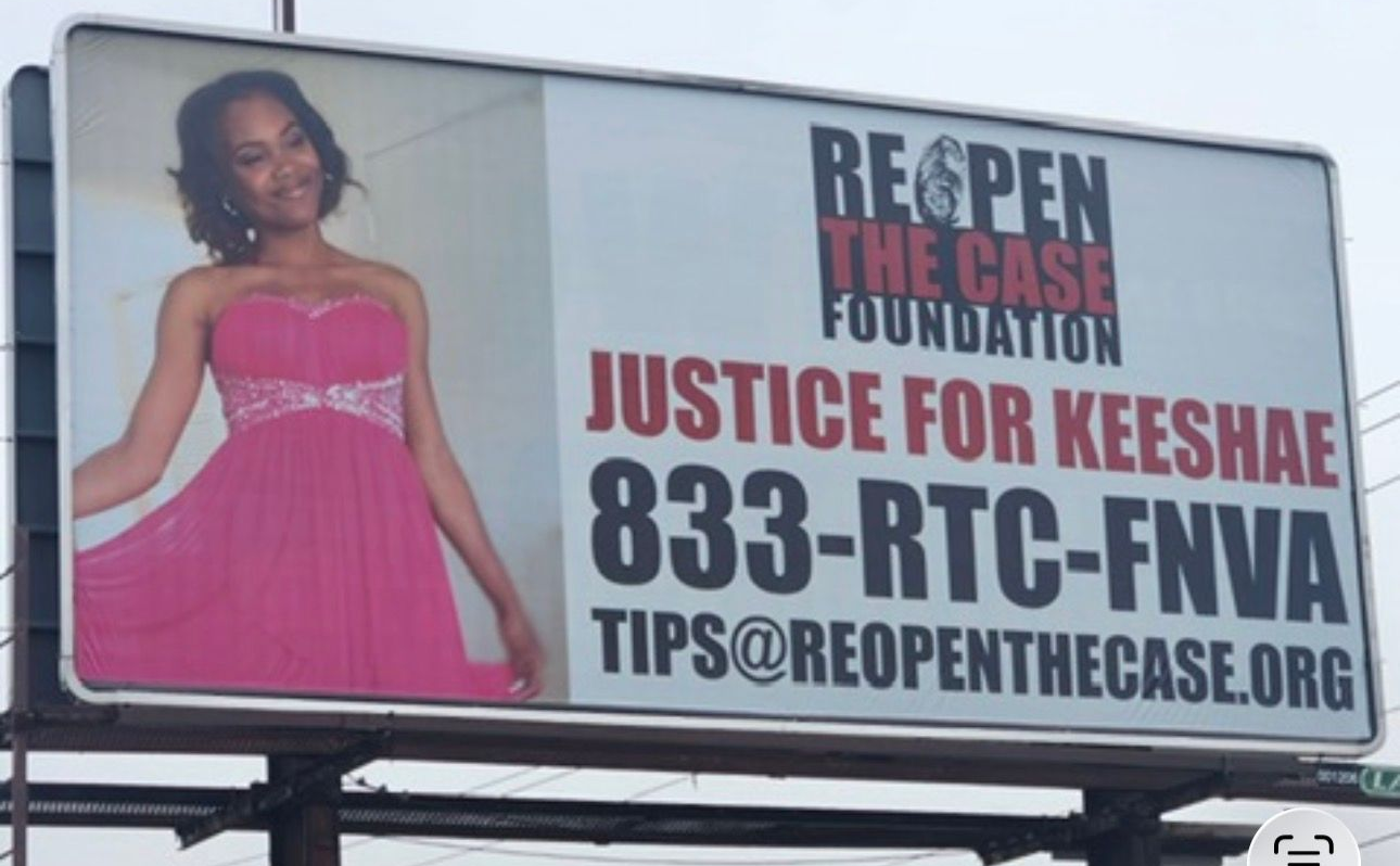 A billboard features a person in a pink dress, reading 