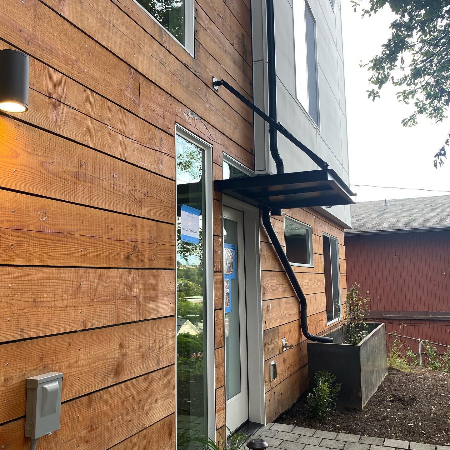 A wooden house with stairs leading up to the front door