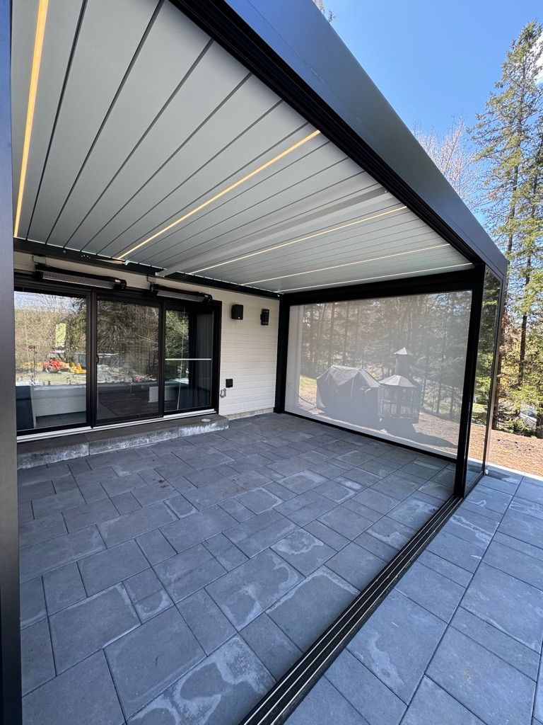 Un patio avec une pergola et des portes coulissantes en verre.