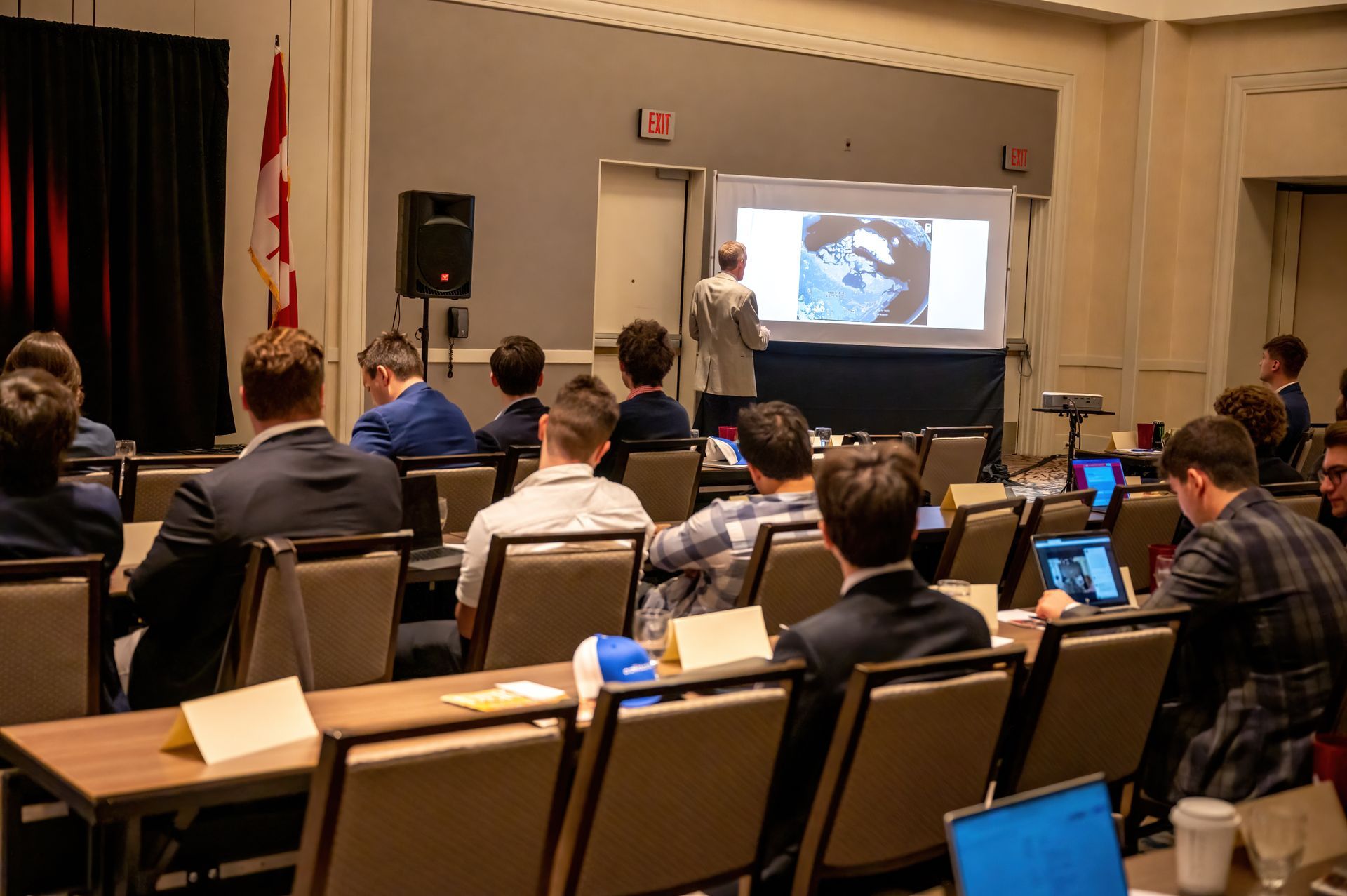 Deke Members and Alumni watching a DKE Conference speaker intently while attending the Deke Conference