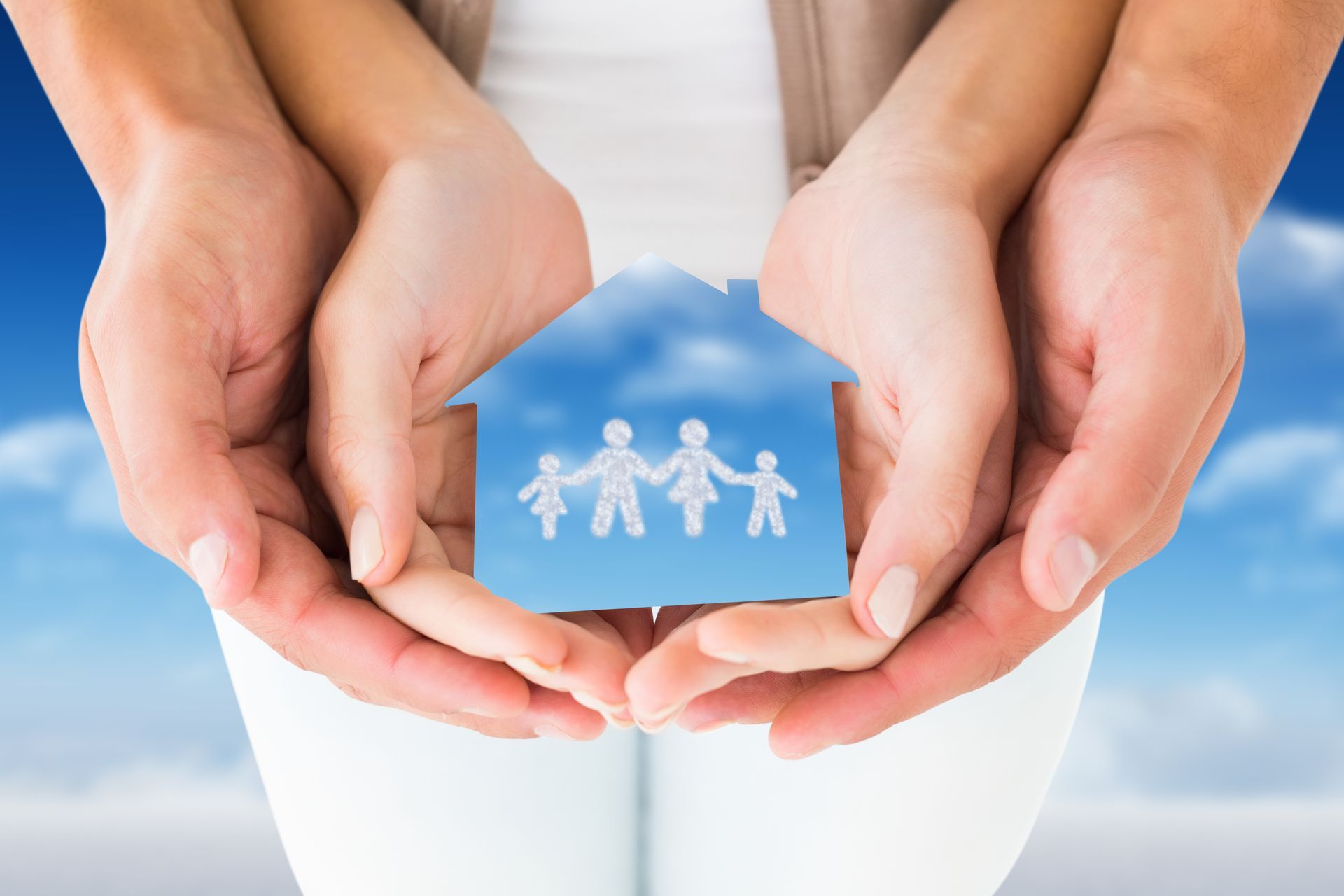 Hands holding a paper house with a family icon, symbolizing home and family protection