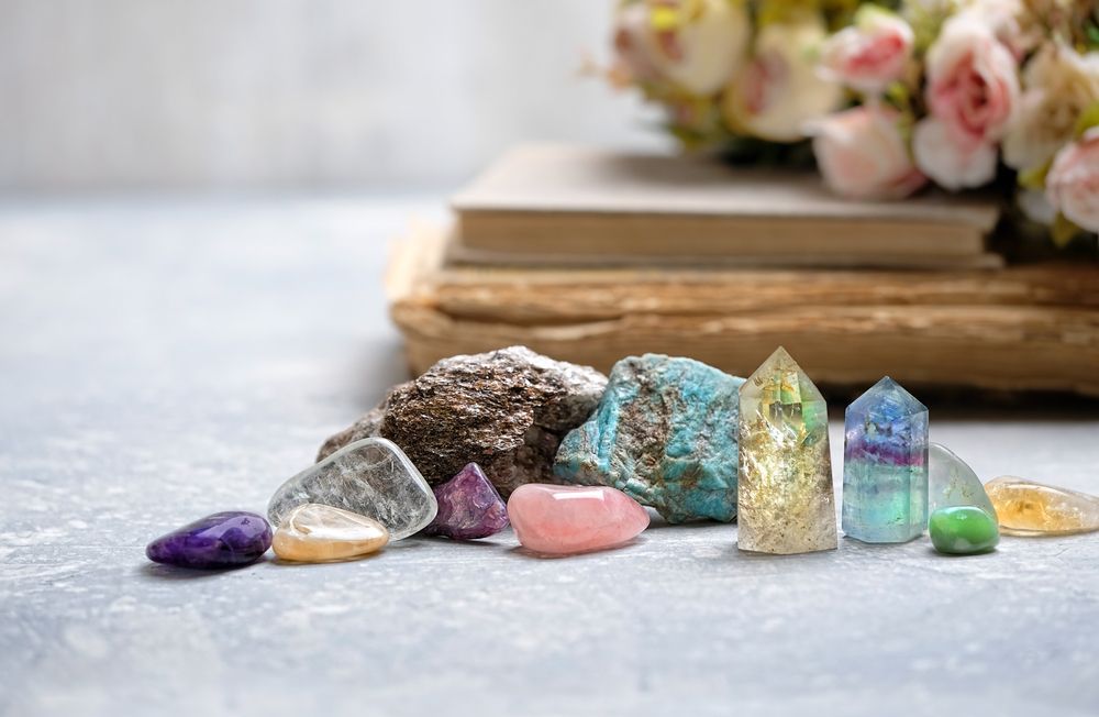 There are many different types of rocks and crystals on the table.