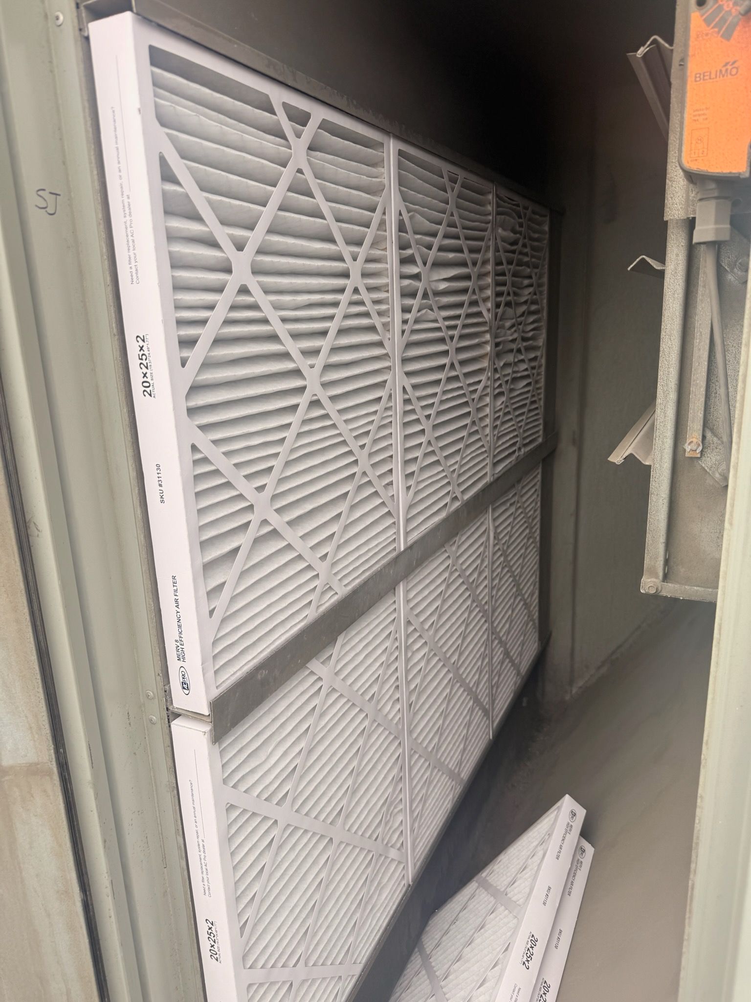 Stacked white filter panels for HVAC maintenance by Preciado Air Conditioning