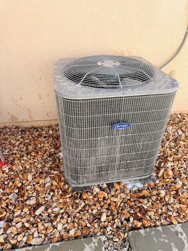 Technician configuring a thermostat after HVAC installation
