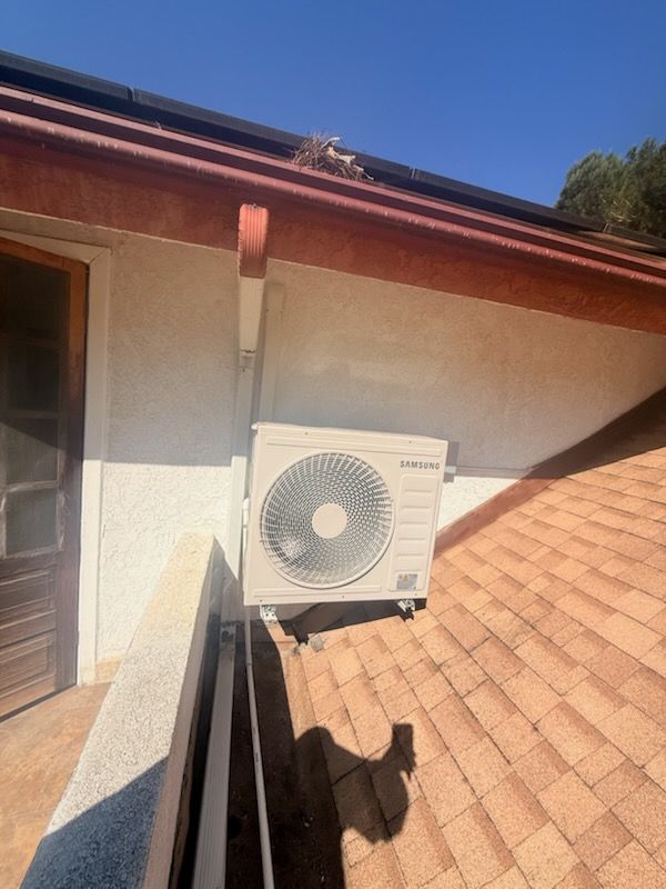 Exterior wall-mounted air conditioner on a beige house in Mission Hills