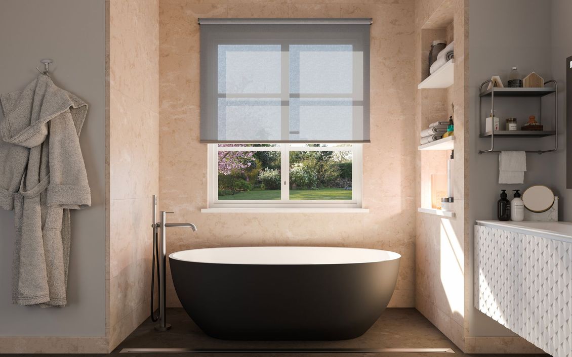 Bagno con vasca nera sotto una finestra con una tenda grigia, un accappatoio appeso sulla sinistra.
