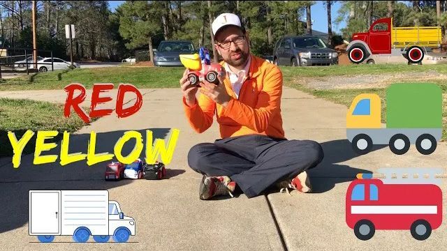 Teacher on sidewalk holding toy vehicles, with big red and yellow text and truck icons around him.