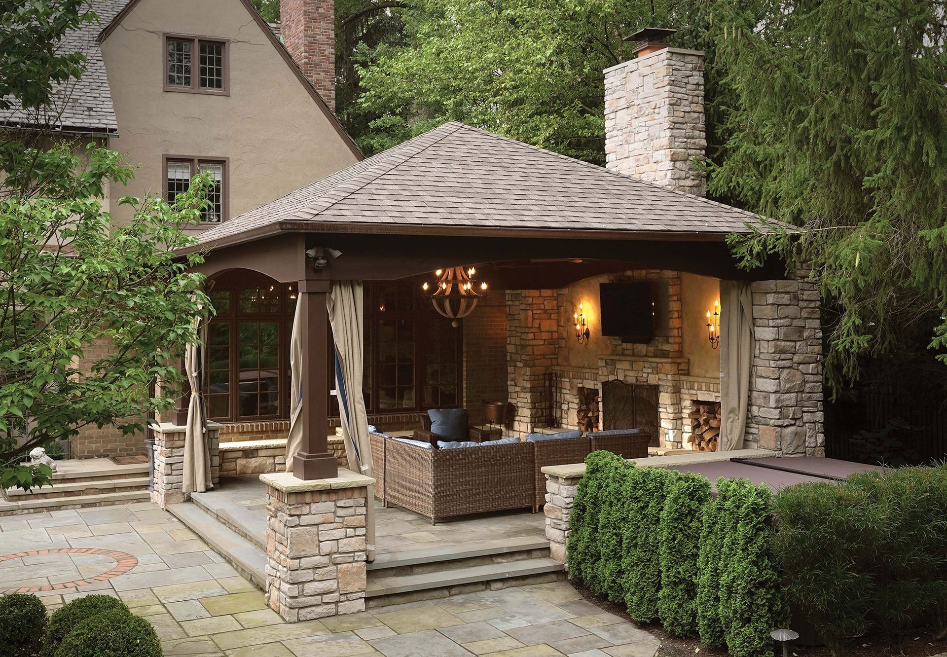 Outdoor pavilion structure with fireplace in Ohio backyard