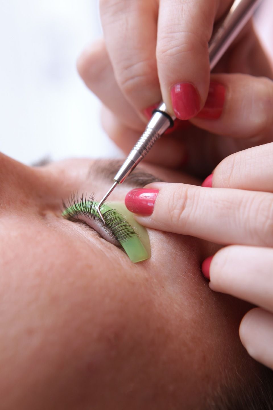 Eyelash extensions for girl in beauty salon. Eyelash care procedures